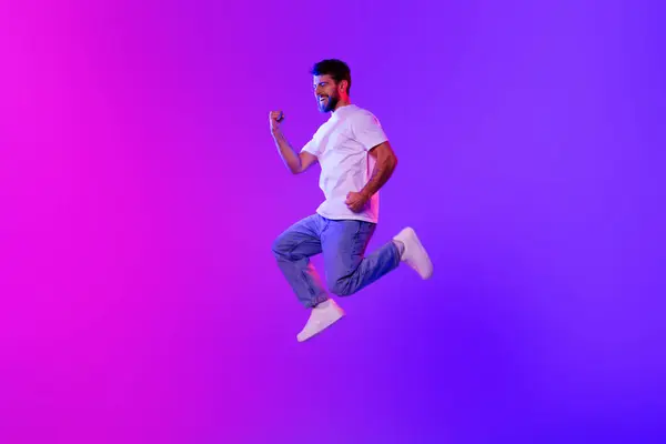 Full Length Joyful Young Guy Gesturing Yes Jumping Mid Air — Stockfoto