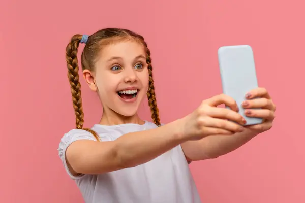 Excited Young Girl Takes Selfie Her Smartphone Looking Thrilled Pink — Stock Photo, Image