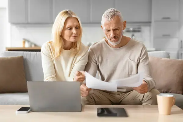 Elderly Couple Analyzing Papers Attention Using Laptop Tablet Reference Home — Stock Photo, Image