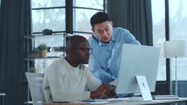 Two Men Sitting Together Focused Computer Screen Appear Engaged Discussion — Stock Video