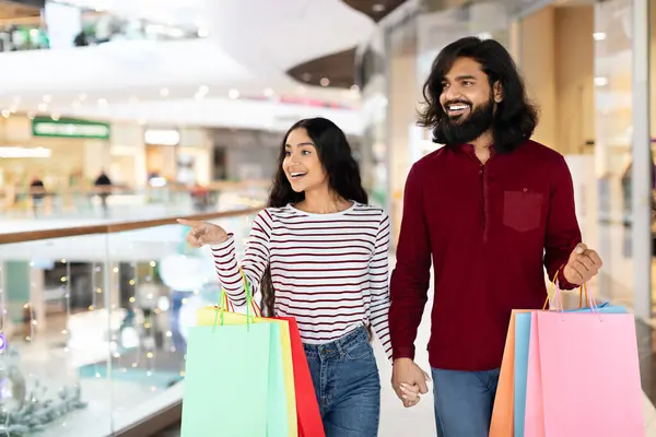 Positive Young Indian Man Woman Carrying Colorful Paper Bags Purchases — Stock Photo, Image