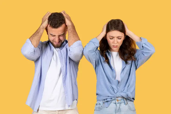 Two Adults Express Frustration Hands Heads Yellow Background — Stock Photo, Image