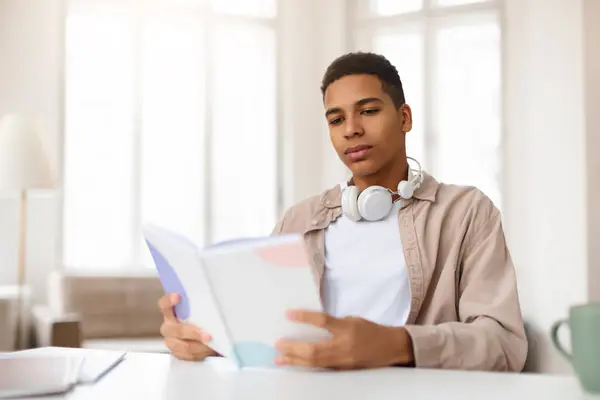 Confident Young Male Headphones His Neck Reads Book While Sitting — Stock Photo, Image