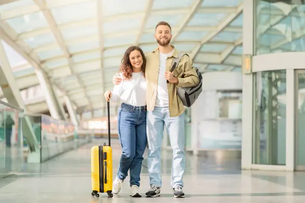 Bir Havaalanı Koridorunda Ele Yürüyen Gülümseyen Genç Çift Birlikte Seyahat — Stok fotoğraf