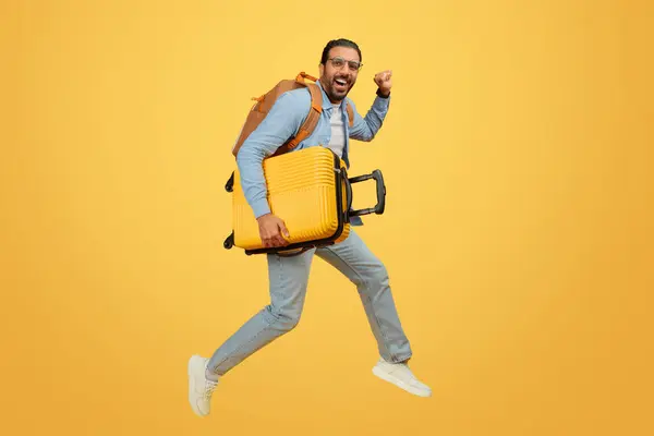Energetic Indian Man Leaping Suitcase Expressing Joy Excitement Travel — Stock Photo, Image
