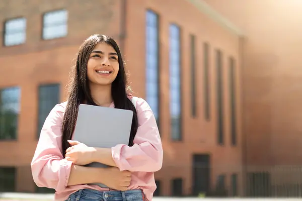 Fröhliche Junge Studentin Mit Geschlossenem Laptop Nachdenklich Nach Oben Blickend — Stockfoto