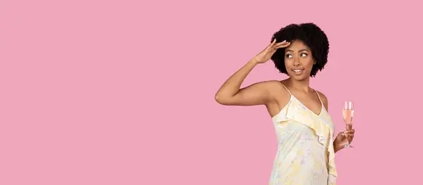 African American Woman Casual Dress Salutes Glass Champagne Pink Background — Stock Photo, Image