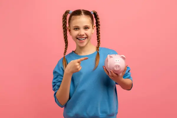Smiling Girl Pointing Piggy Bank Symbolizing Importance Savings Financial Awareness — Stock Photo, Image