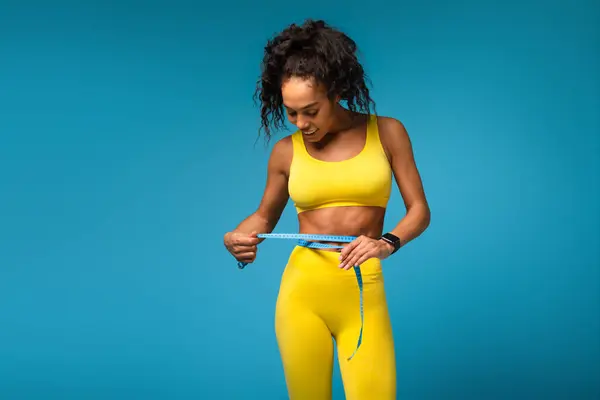 Fitness Conscious African American Woman Yellow Gym Attire Measuring Her — Stock Photo, Image