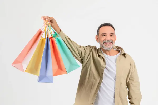 Smiling Older Man Displays Multiple Colored Shopping Bags Indicating Pleasant — Stock Photo, Image