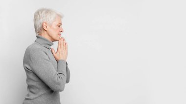 A side profile of an elderly European woman praying forward, capturing the contemplative nature and forward-thinking attitude of s3niorlife clipart