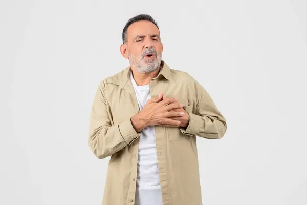 Senior Man Stands White Background Clutching His Chest Pain Pained — Stock Photo, Image