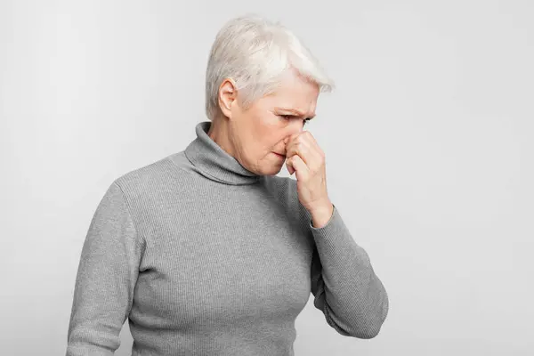 Elderly European Woman Stands Her Nose Closed Possibly Experiencing Bad — Stock Photo, Image