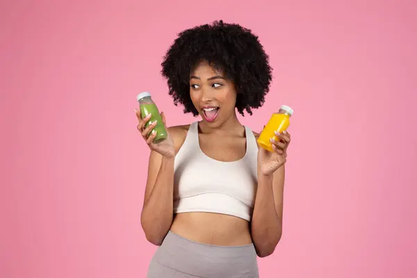 Happy African American Woman Comparing Two Bottles Colorful Nutritious Juices — Stock Photo, Image