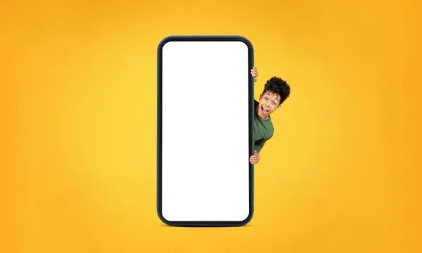 Smiling Young African American Man Hiding Giant Smartphone Blank Screen — Stock Photo, Image