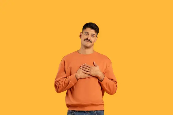 Young Man Mustache Wearing Orange Sweater Smiles Makes Heart Gesture — Stock Photo, Image