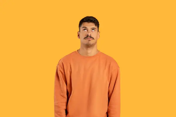 Millennial Guy Moustache Looks Puzzled Expression Funny Isolated Orange Background — Stock Photo, Image