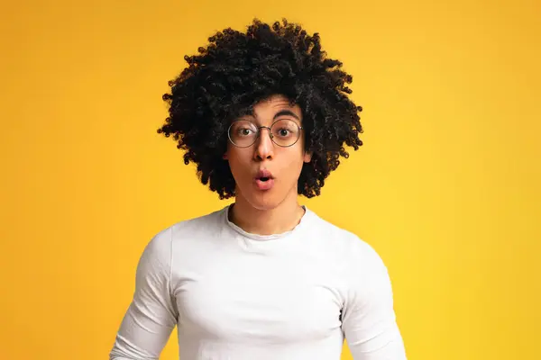 stock image Amazed black millennial guy opened mouth in shock, orange studio background