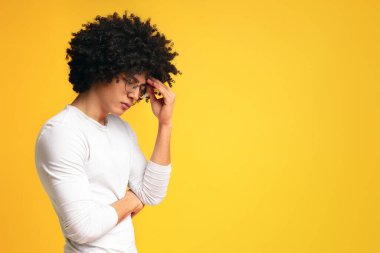 İlham eksikliği. Depresif Afrikalı adam düşünceler derin, alnına dokunmadan, boş alan ile turuncu panorama arka plan