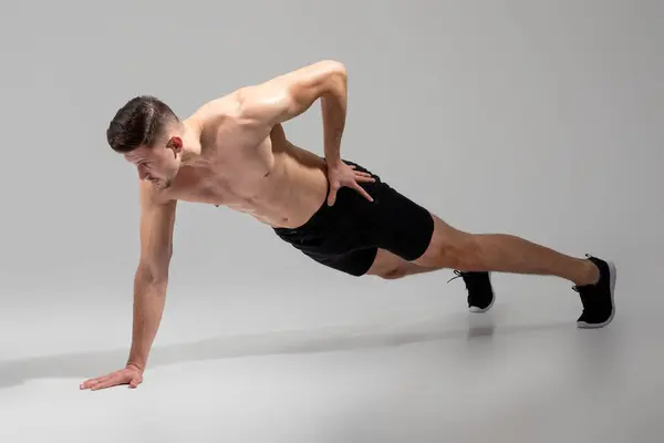 Man Balancing One Arm While Performing Push Engaging His Core — Stock Photo, Image