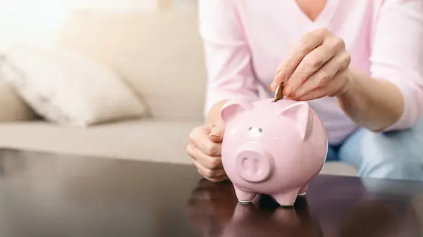 Cropped Woman Inserting Coin Bright Pink Piggy Bank Pushes Coin — Stock Photo, Image