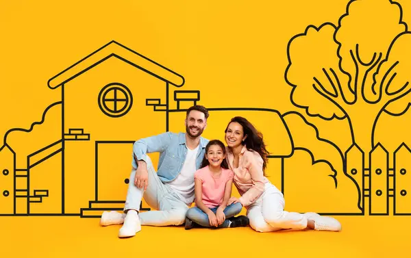 A family of three, consisting of two parents and daughter, are seated on the ground in front of drawn suburban house on yellow wall background