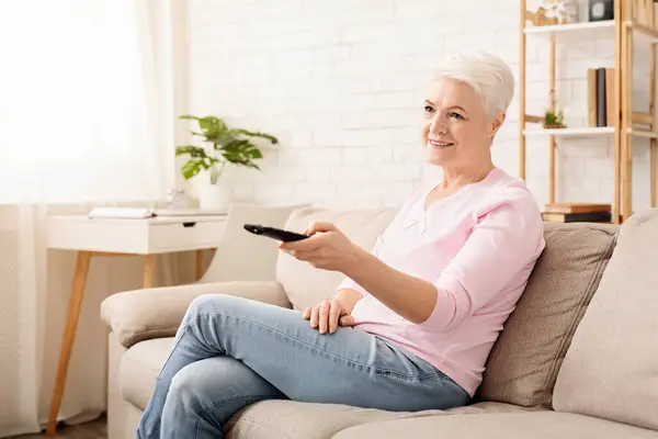 Senior Woman Sitting Couch Indoors Holding Remote Control Her Hand — 图库照片