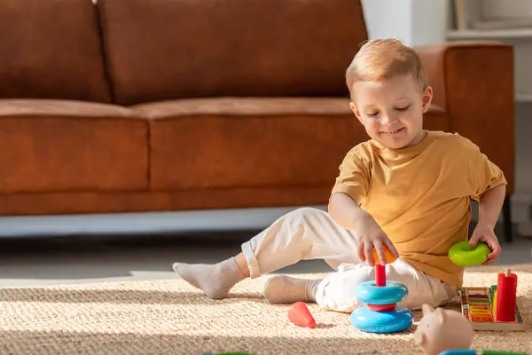 Young Boy Engrossed Playing Various Toys Floor Room Surrounded Different Stock Image