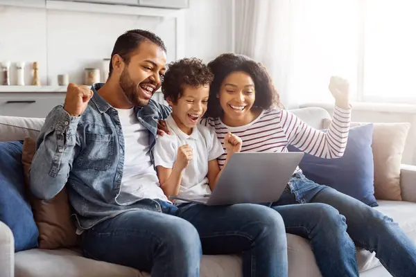 Black Family Seated Couch Closely Gathered Laptop All Looking Screen Stock Image