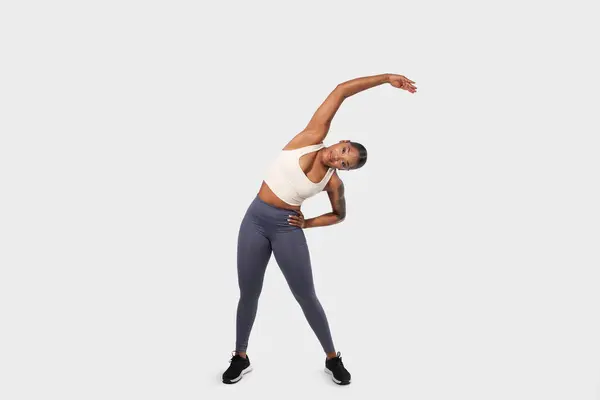 Young African American Woman Captured Moment Fitness Performing Side Stretch Stock Picture