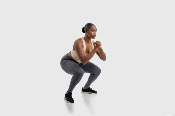 Focused African American Woman Athlete Engaged Strength Building Exercise Routine Stock Photo