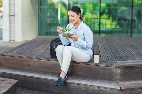 Asian Businesswoman Sitting Steps Outdoors While Eating Salad She Dressed Stock Image