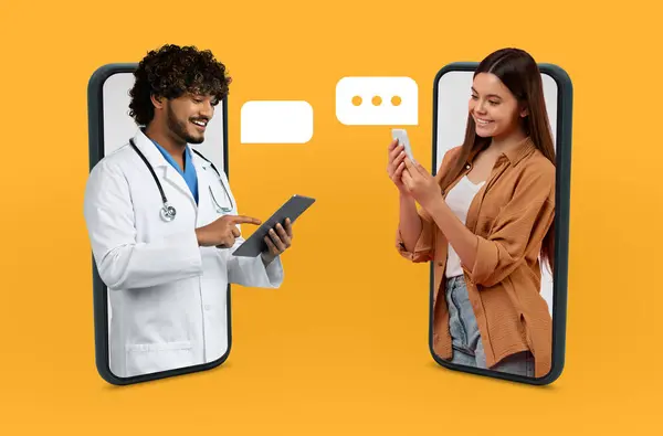 stock image A doctor in a white coat is using a tablet for a telemedicine consultation with a patient who is holding a smartphone. They appear to be communicating through a virtual platform