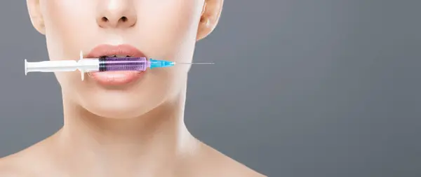 stock image A woman with a syringe in her mouth, appearing to be in distress or experiencing a drug-related issue. The image captures a risky and concerning behavior that may have serious health implications.