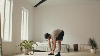 Güçlü ve sağlıklı bir vücut. Milenyum çocuğu evde esneme egzersizi yapıyor.