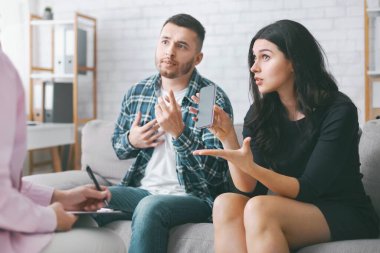 Genç bir çift terapi seansı sırasında kanepede oturur. Akıllı telefon kullanımlarını, elinde akıllı telefon tutan ve sol eliyle işaret eden kadınla tartışıyorlar.