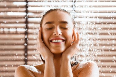 Woman Enjoying Cool Shower, Standing Under Water Jet
