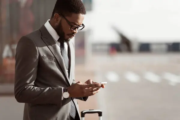 stock image Ordering Taxi. Afro Businessman Using Mobile Phone App, Arriving At Airport, Copy Space