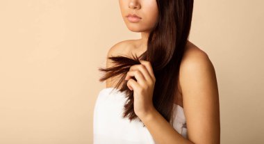 Hair Care Problems. Lady Holding Damaged Split Hairs Over Beige Background, Copy Space, Cropped clipart