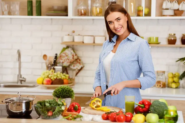 stock image Cooking Vegetable Salad. Happy Woman Cutting Pepper On Kitchen Table, Copy Space