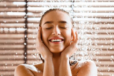 Woman Enjoying Cool Shower, Standing Under Water Jet