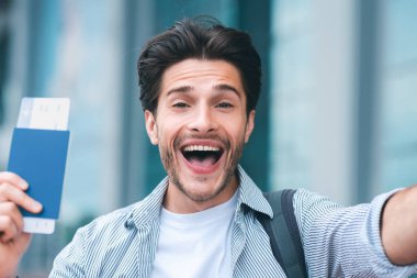 Sonunda macera. Duygusal adam pasaport ve biletlerle yeni seyahatlerden zevk alıyor.