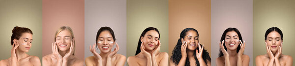 Семь женщин с разными тонами кожи и цветами волос улыбаются, нанося кремовый продукт на их лица перед семью твердыми цветовыми фонами. У каждой женщины руки на щеках.