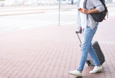 Otobüs durağına gidiyorum. Bagaj, boş alan ile ulaşım durağına yürüyen turist
