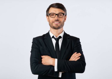 Kendine güvenen işadamı, kameraya gülümseyen, ellerini beyazların üzerinden geçiren. İzole edilmiş