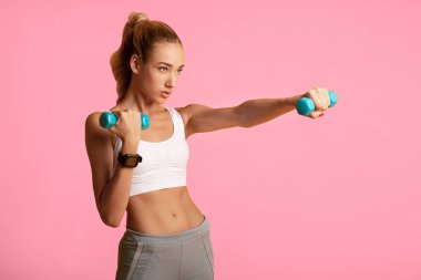 Fit Genç Kadın Yellow Studio Arka Plan Üzerinde Dumbbell Boks Kardiyo Egzersiz yapıyor. Spor ve Sağlık