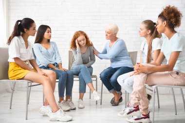 Terapi gören depresyondaki kızı rahatlatacak psikolog. İçeride Çember içinde oturan kadın destek grubuyla. Seçici Odaklanma