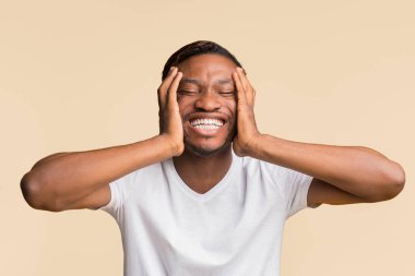Laughter. Funny Afro Man Laughing Clutching Head Standing Over Yellow Studio Background