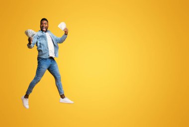 Büyük Galibiyet. Neşeli Afro Adam Nakit Tutuyor, Havaya Atlıyor ve Heyecanla Çığlık Atıyor