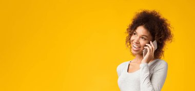 Telefon var. Afro hamile kadın cep telefonuyla doktoruyla pembe arka planda konuşuyor.